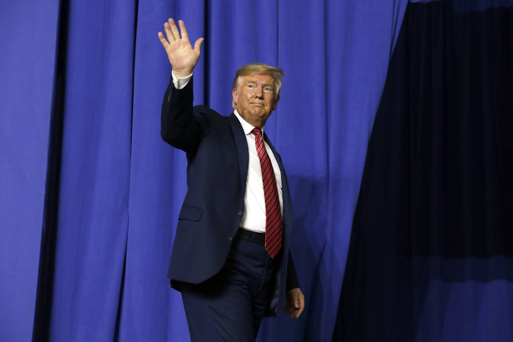 President Donald Trump waves after speaking with Australian Prime Minister Scott Morrison at Pr ...