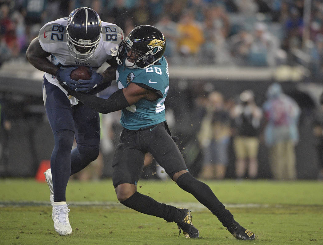 Jacksonville Jaguars cornerback Jalen Ramsey (20) stops Tennessee Titans tight end Delanie Walk ...