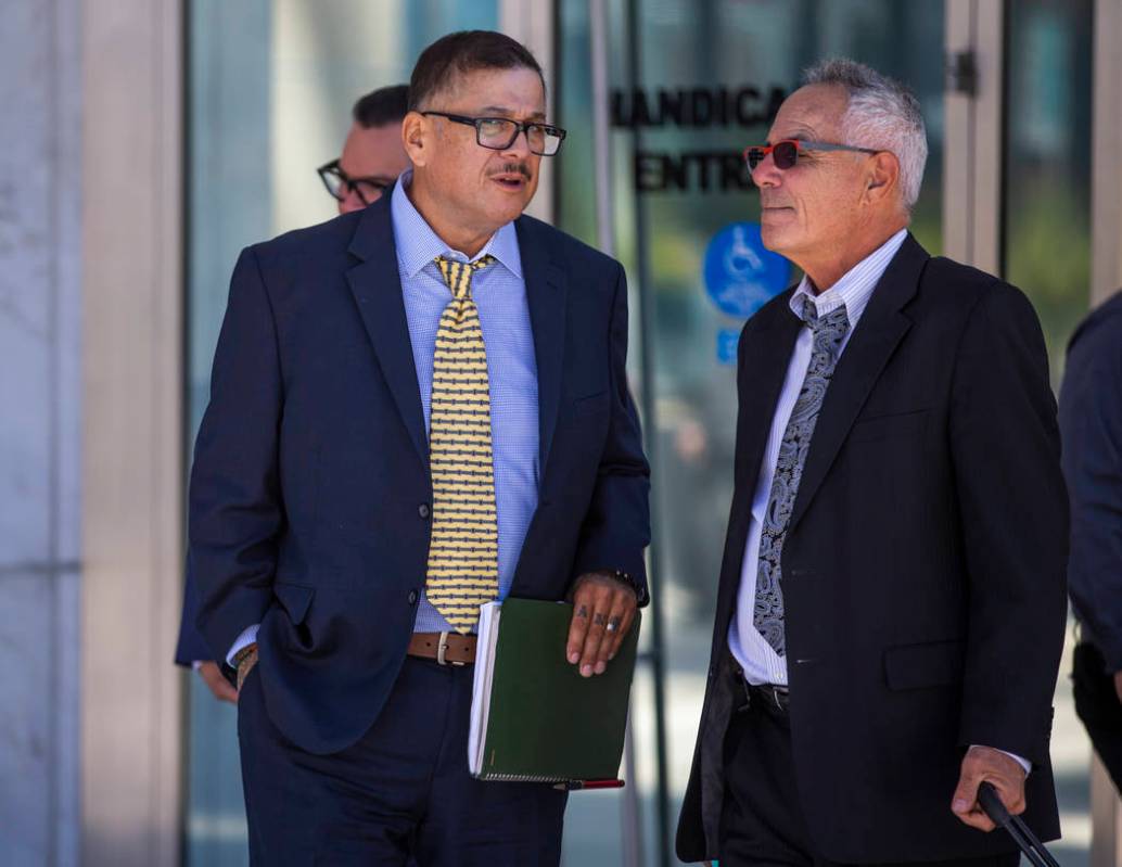 Defendant Cesar Morales, left, talks with counselor Shawn Perez outside the Lloyd D. George Cou ...