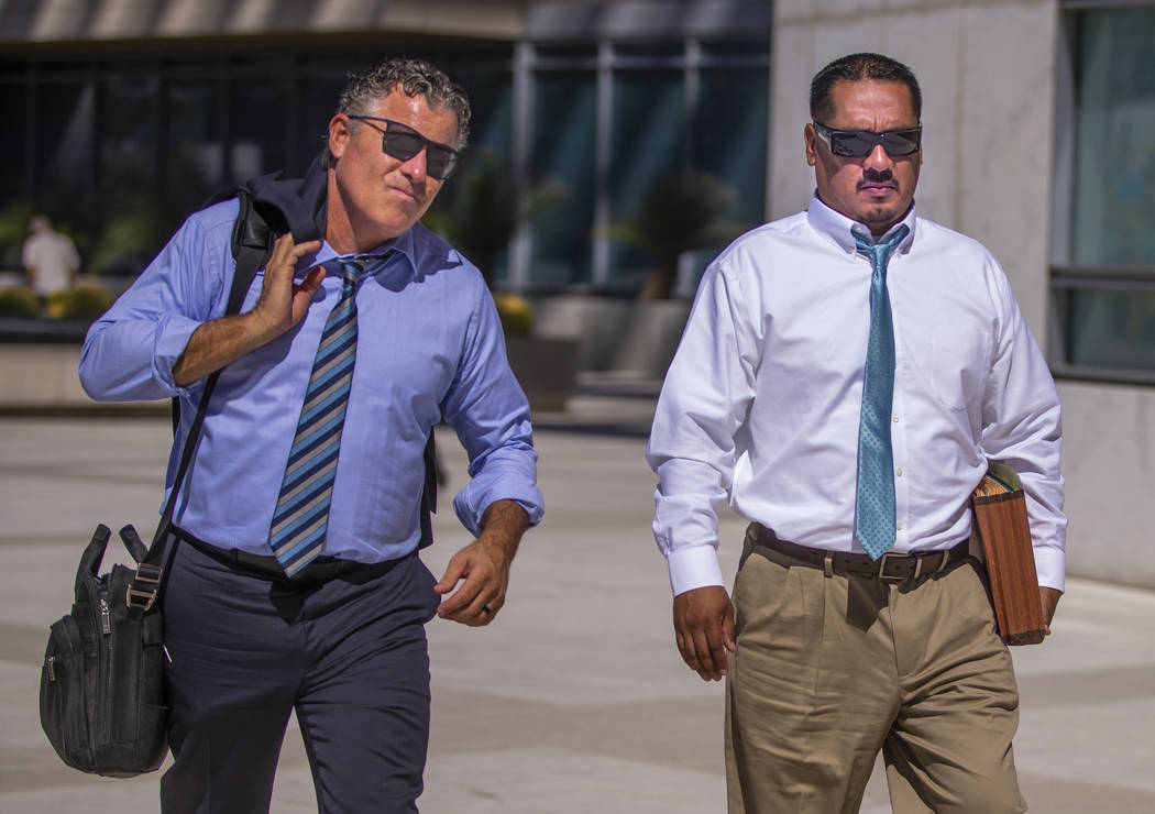 Counselor Mark Fleming, left, walks out with defendant Albert Lopez past defendant Bradley Camp ...