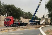 In this Tuesday, May 28, 2019 photo, Iraqi security forces remove concrete blast walls at the G ...