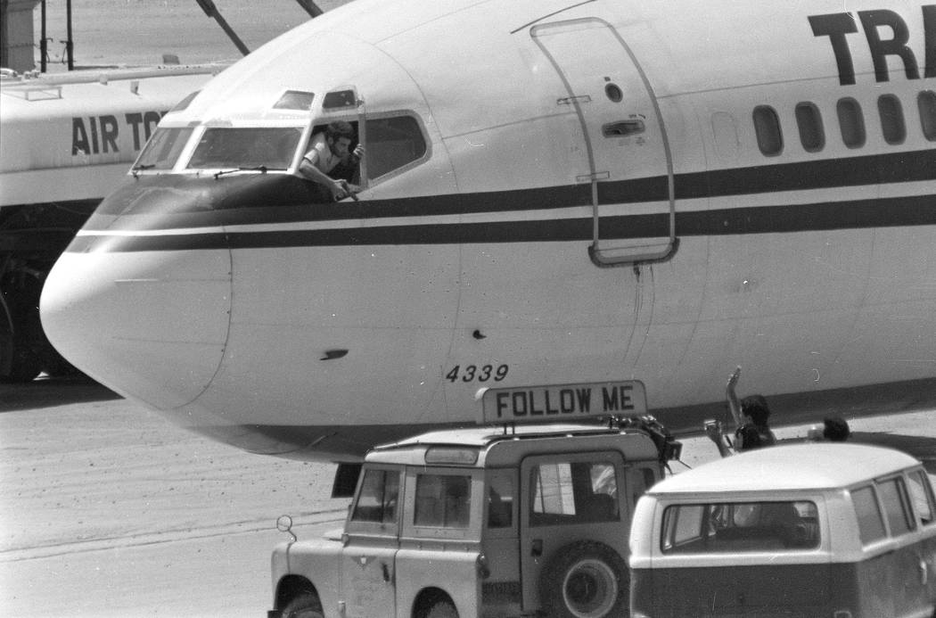 FILE - In this Wednesday, June 19, 1985 file photo, a hijacker points a weapon toward an ABC ne ...