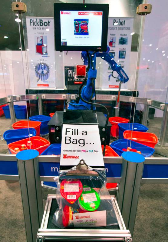 A robot from Chicago Electric packs school lunches for kids through Blessings in a Backpack at ...