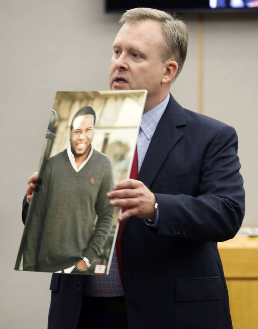 Assistant District Attorney Jason Hermus shows a photo of Botham Jean to the jury during his op ...