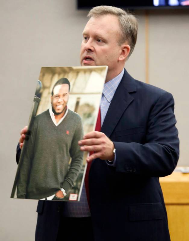 Assistant District Attorney Jason Hermus shows a photo of Botham Jean to the jury during his op ...