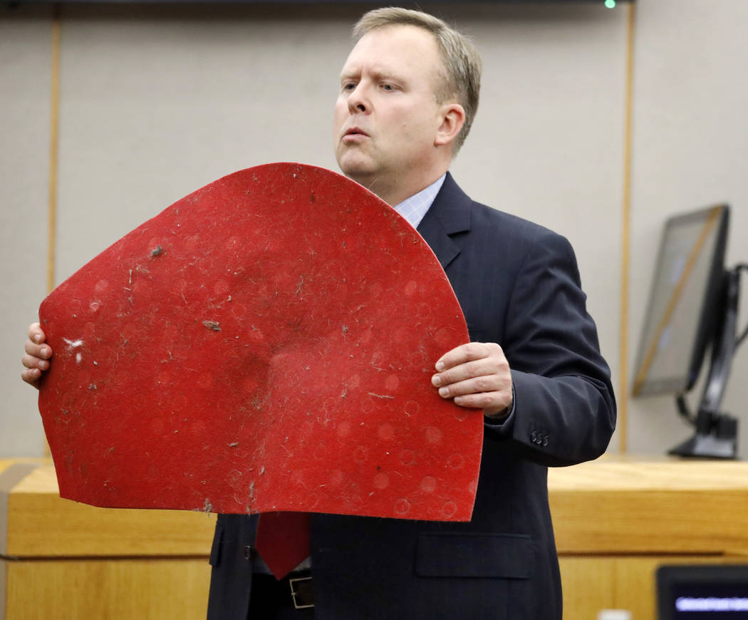 Assistant District Attorney Jason Hermus shows Botham Jean's doormat to the jury during his ope ...