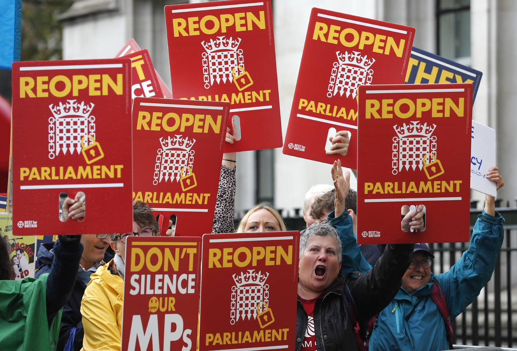 Anti-Brexit supporters react as they gather outside the Supreme Court in London, Tuesday, Sept. ...