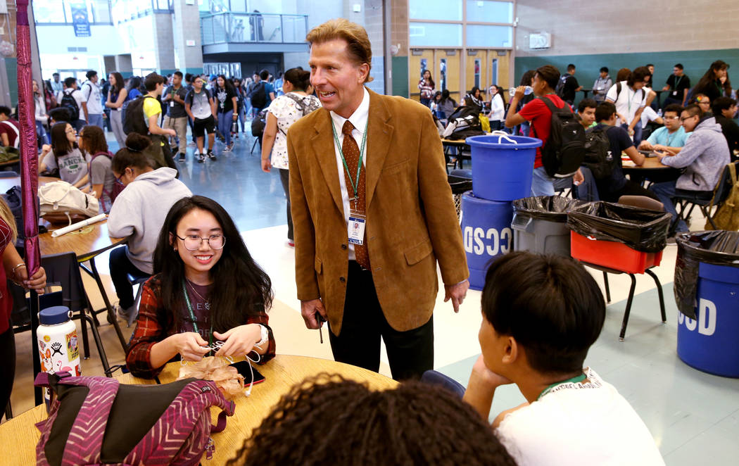 Principal James Kuzma visits with juniors Claire Pormento and Alva Yuke during first lunch at R ...
