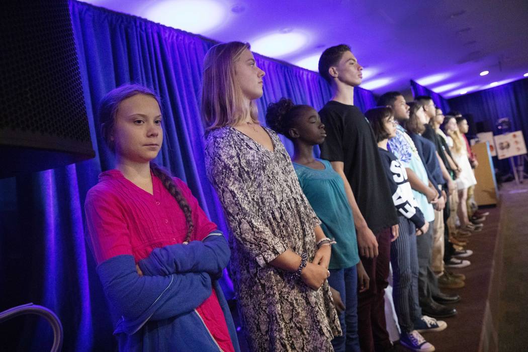 Greta Thunberg, left, is joined by other child petitioners to announce a complaint they will fi ...