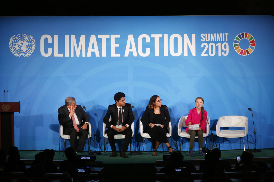 United Nations Secretary-General Antonio Guterres, far left, and young environmental activists ...