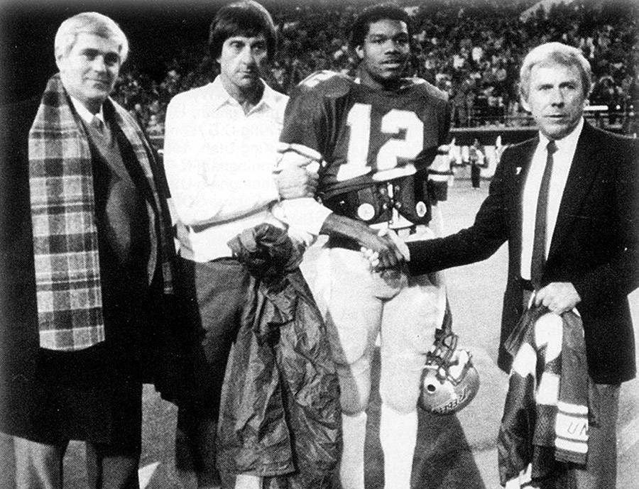 UNLV quarterback Randall Cunningham's No. 12 is retired at halftime of a 1984 game against No. ...