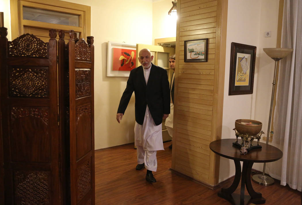 Former Afghan President Hamid Karzai arrives for an interview in Kabul, Afghanistan, Tuesday, S ...