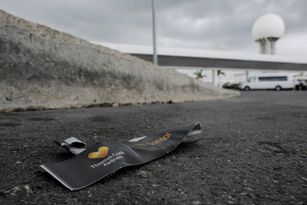 A Thomas Cook luggage tag lays discarded in the street, outside the Cancun airport in Mexico, M ...