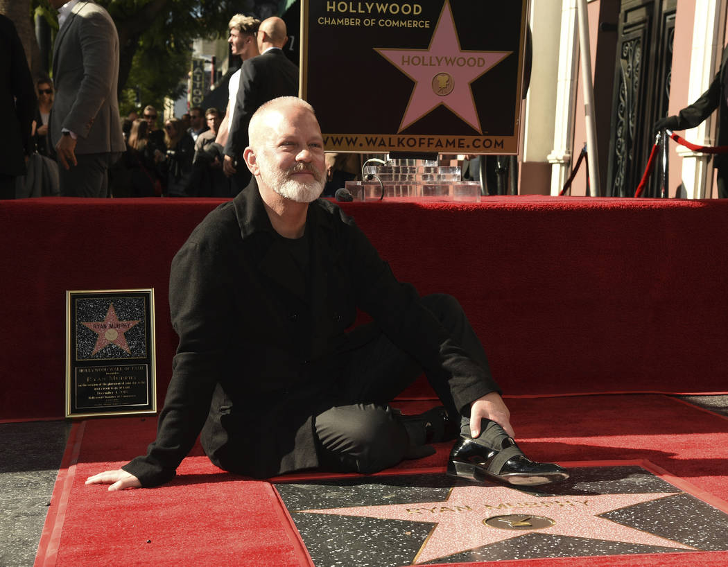 Screenwriter/television producer/director Ryan Murphy poses behind his new star during a ceremo ...