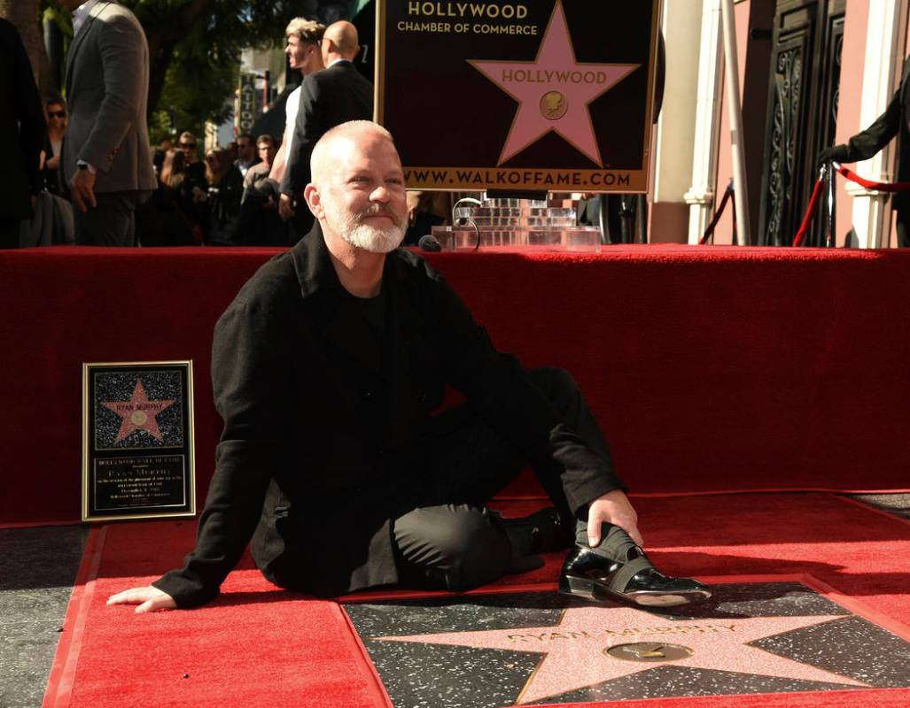 Screenwriter/television producer/director Ryan Murphy poses behind his new star during a ceremo ...