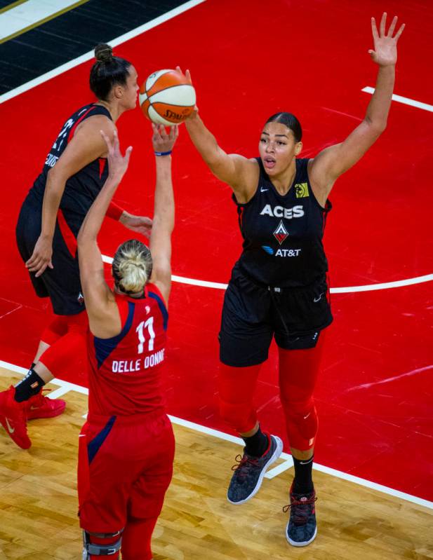 Washington Mystics forward Elena Delle Donne (11, left) has a shot deflected by Las Vegas Aces ...