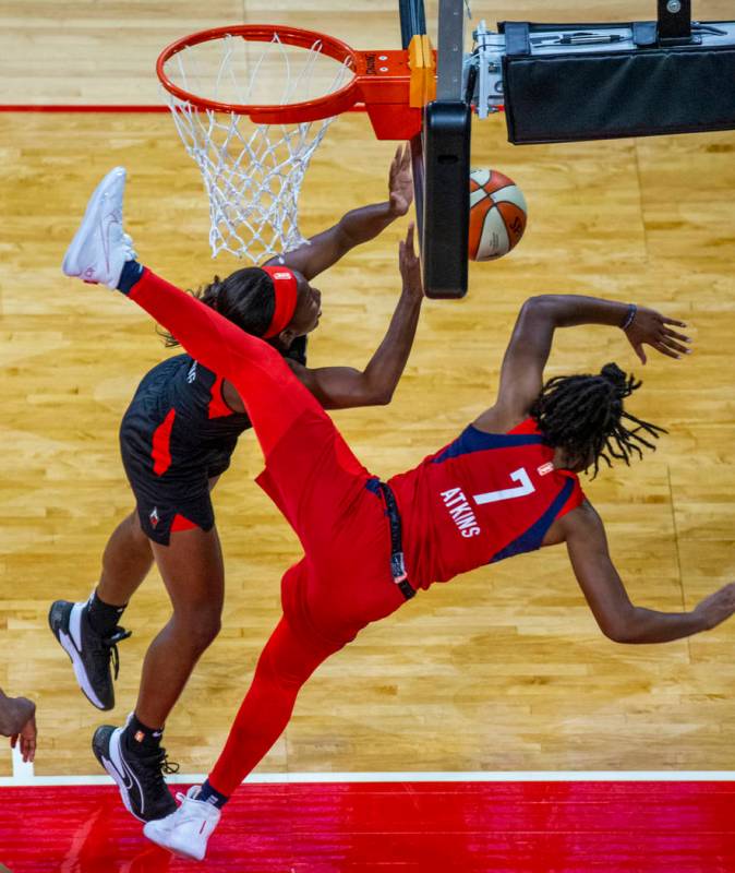 Las Vegas Aces guard Jackie Young (0) is fouled hard by Washington Mystics guard Ariel Atkins ( ...