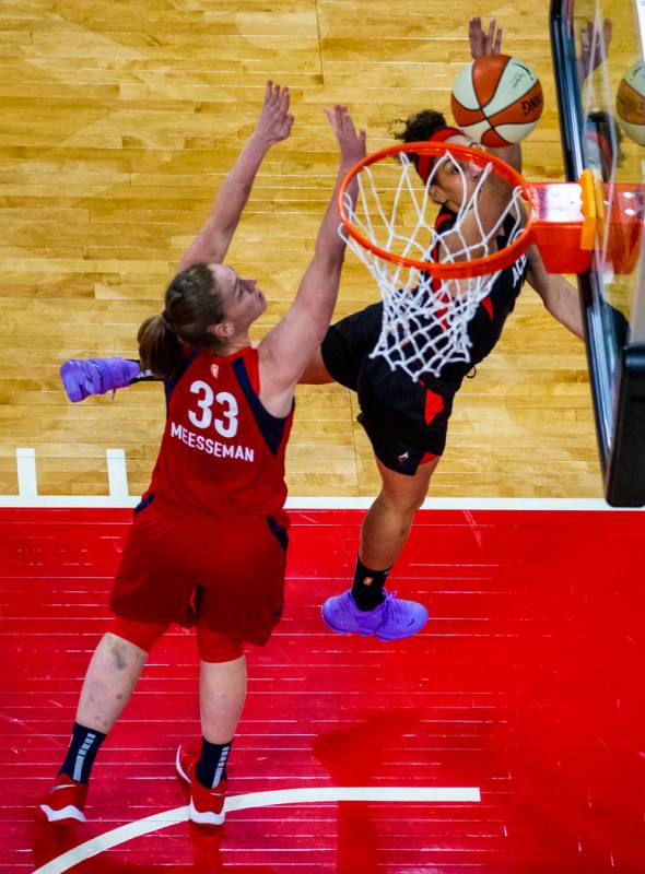 Las Vegas Aces forward Dearica Hamby (5) gets inside of a basket over Washington Mystics center ...