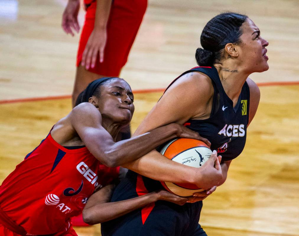 Washington Mystics forward LaToya Sanders (30, left) fights for the ball with Las Vegas Aces ce ...