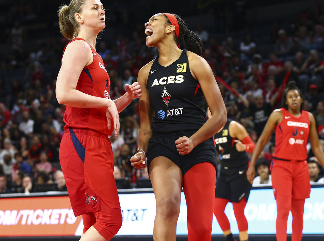 Las Vegas Aces' center A'ja Wilson, right, reacts after drawing a foul in front of Washington M ...