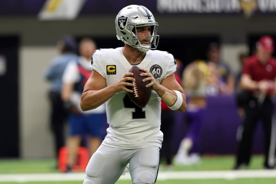 Oakland Raiders quarterback Derek Carr (4) looks for an open receiver during the first half of ...