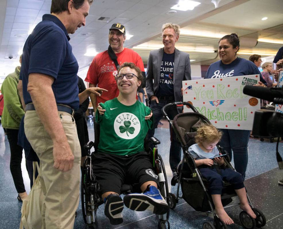 Miracle Flight CEO Mark Brown, left, talks with Michael Perrino, 16, from Mashpee, Mass., ...