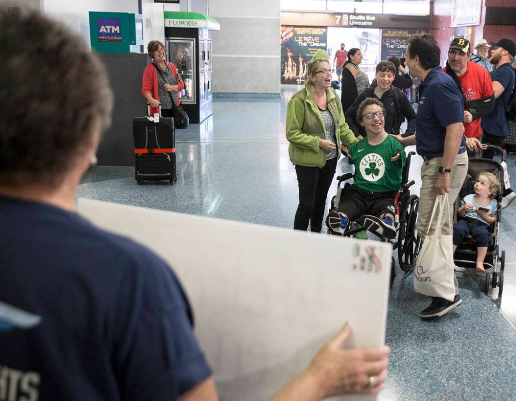 Miracle Flight CEO Mark Brown, top/right, greets Misty Perrino and son Michael, 16, from M ...