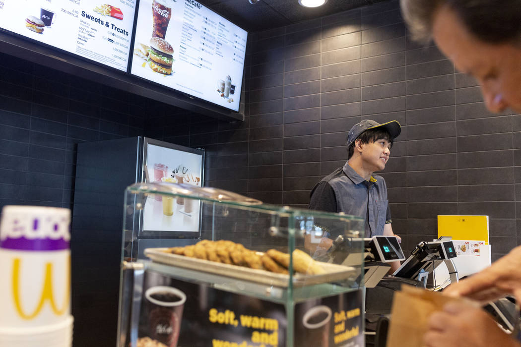 Crew member Jacob Zamora takes a customer's order at the McDonald's on the corner of Sahara Ave ...