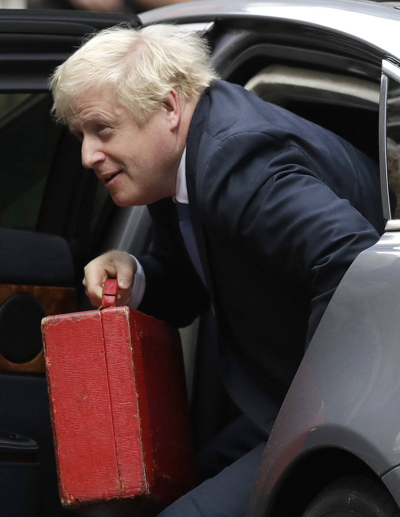 British Prime Minister Boris Johnson, center, arrives at Downing Street in London, Wednesday, S ...