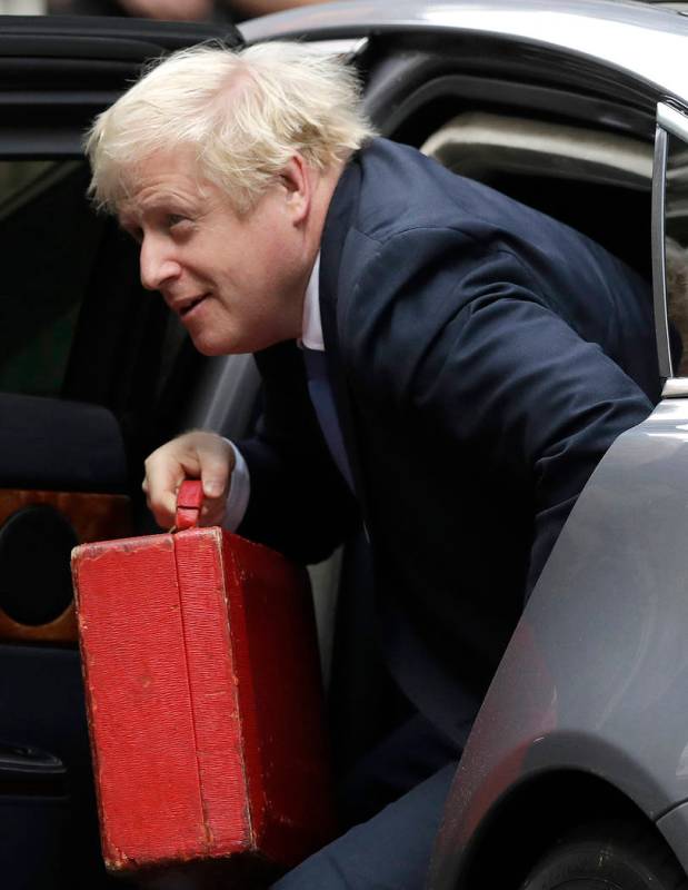 British Prime Minister Boris Johnson, center, arrives at Downing Street in London, Wednesday, S ...