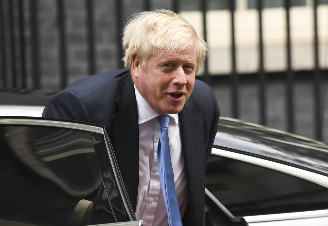 Britain's Prime Minster Boris Johnson arrives at 10 Downing Street, in London, on Wednesday, Se ...