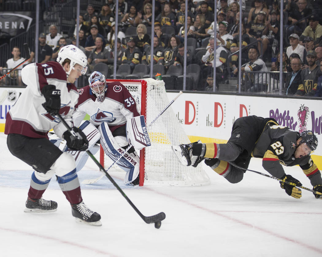 Vegas Golden Knights center Patrick Brown (23) takes a tumble while trying to take the puck fro ...