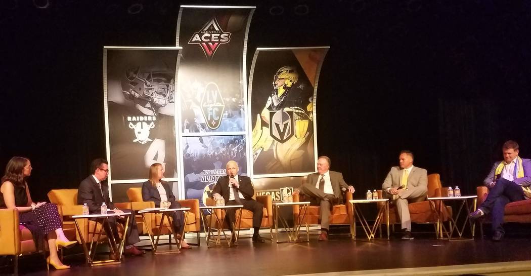 Marc Badain, center, president of the Oakland Raiders, makes a point about Allegiant Stadium, w ...