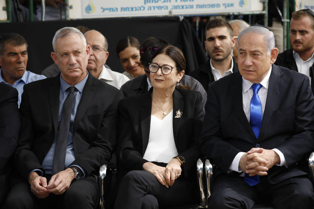 In a Thursday, Sept. 19, 2019, file photo, Blue and White party leader Benny Gantz, left, Esthe ...