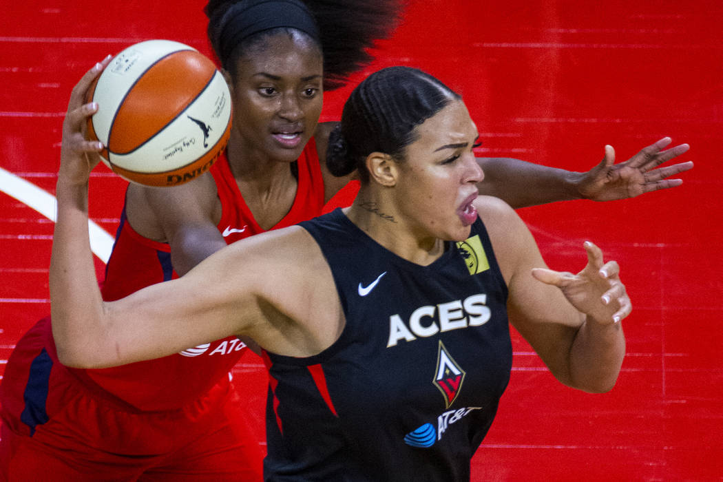 Las Vegas Aces center Liz Cambage (8, front) looks for a pass over Washington Mystics forward L ...