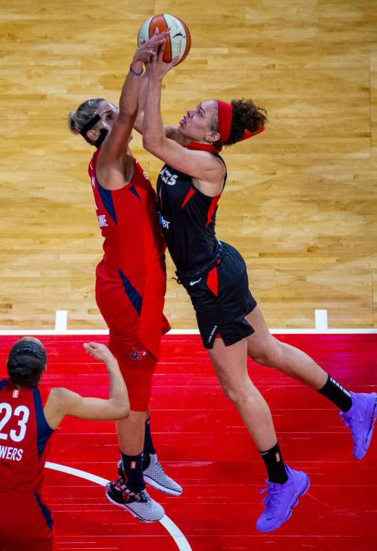 Washington Mystics forward Elena Delle Donne (11, left) makes a critical stop on Las Vegas Aces ...