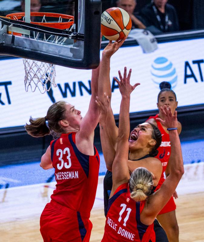 Las Vegas Aces center Liz Cambage (8, right) goes up for a shot attempt under tight defense by ...