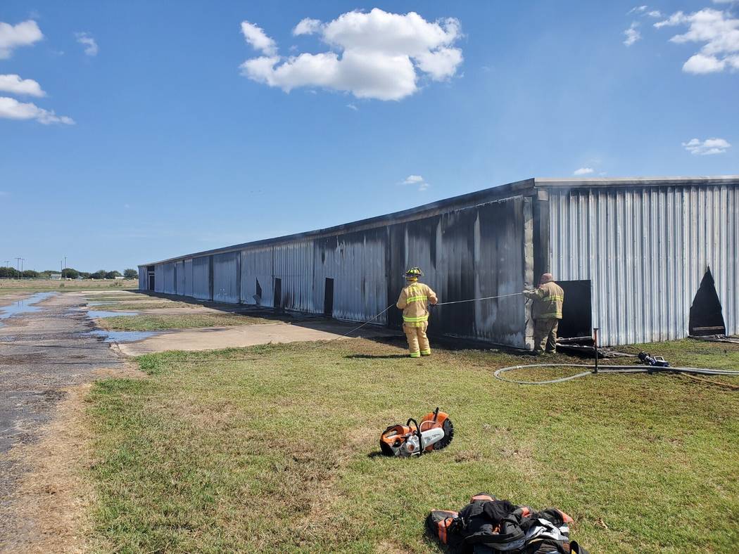 Firefighters work the scene of a fire in a hangar at the Caddo Mills, Texas, airport, Wednesday ...