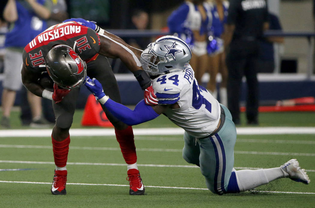 Tampa Bay Buccaneers running back Bruce Anderson III is stopped by the face mask by Dallas Cowb ...