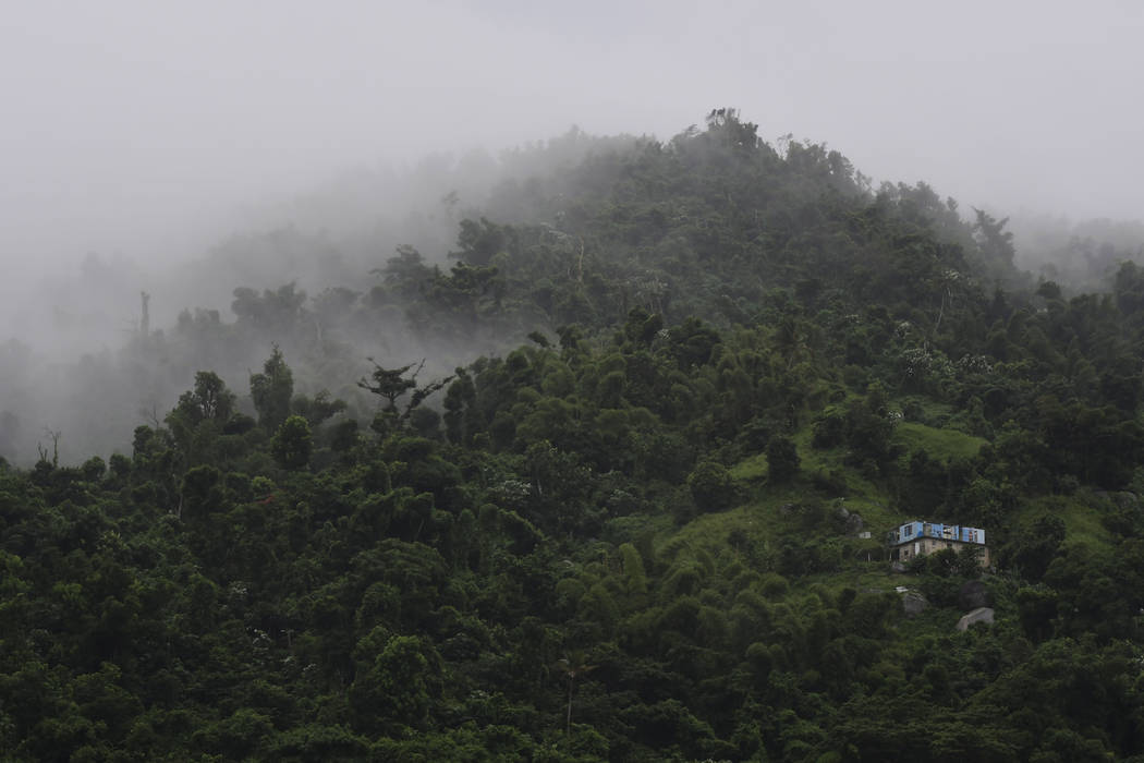 A house without a roof is surrounded by clouds on a mountain in Yabucoa, Puerto Rico, Tuesday, ...