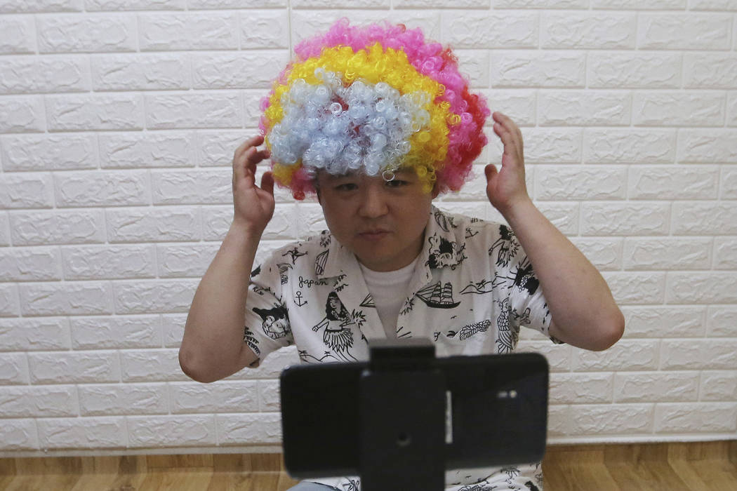 In this July 18, 2019, photo, North Korean refugee Jang Myung-jin films himself in a demonstrat ...