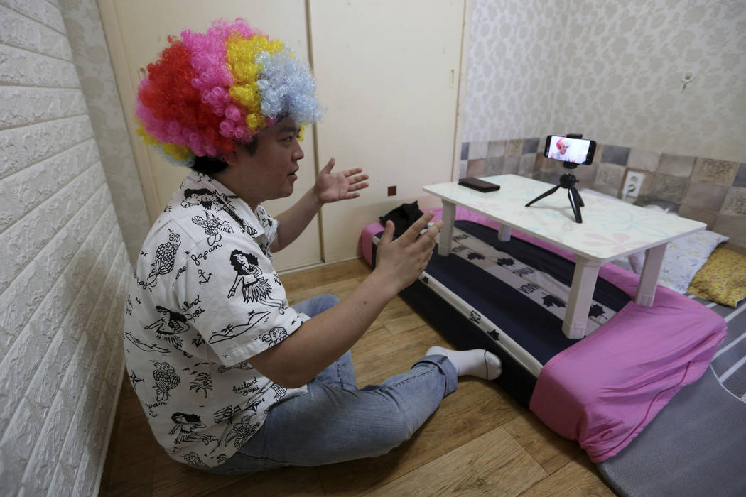 In this July 18, 2019, photo, North Korean refugee Jang Myung-jin films himself in a demonstrat ...