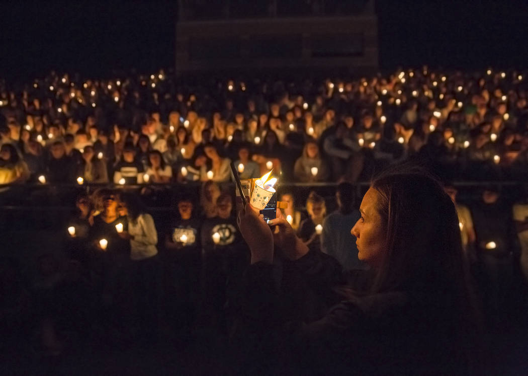 Junior Catriona Palmer, right, takes a photo of attendees during a vigil on April 3, 2018, at C ...