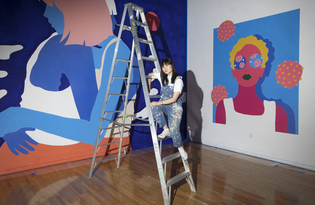 Amanda Phingbodhipakkiya, a neuroscientist-turned-artist, stands in front of her work at her ex ...