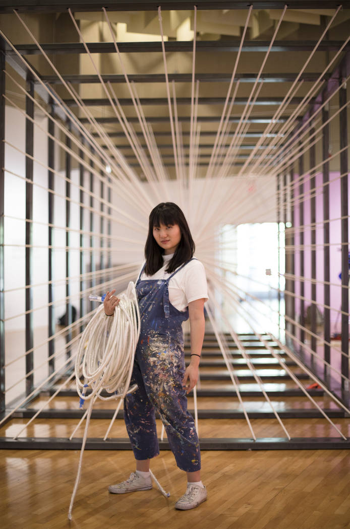 Amanda Phingbodhipakkiya, a neuroscientist-turned-artist, stands in front of one of her install ...