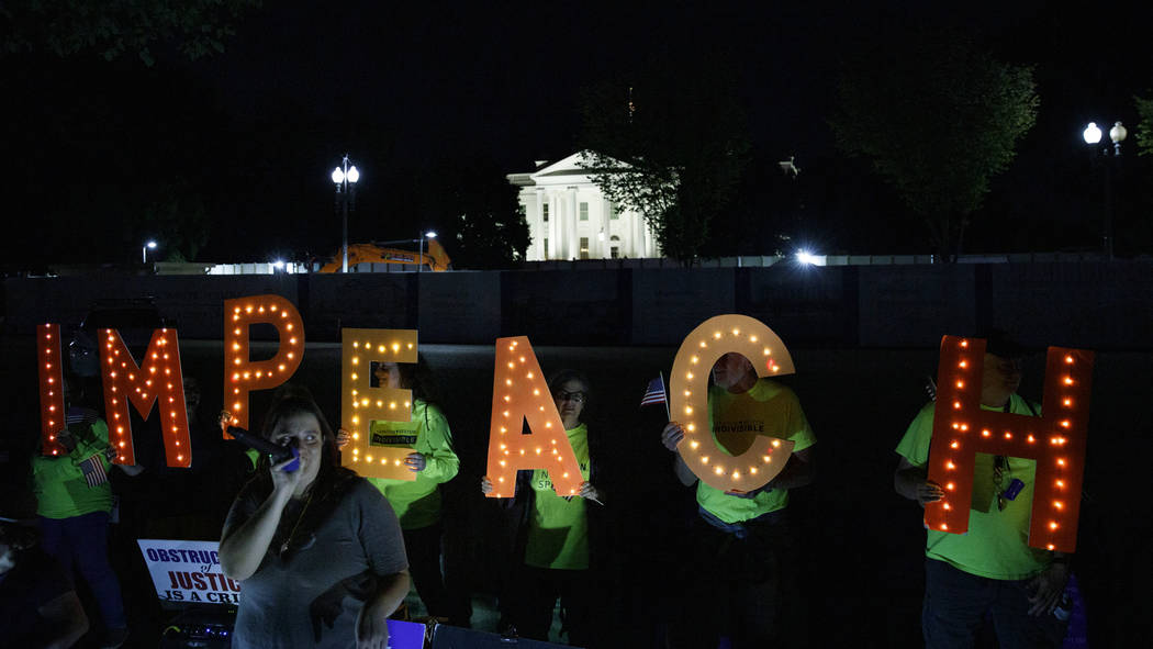 Protesters with "Kremlin Annex" call to impeach President Donald Trump in Lafayette S ...