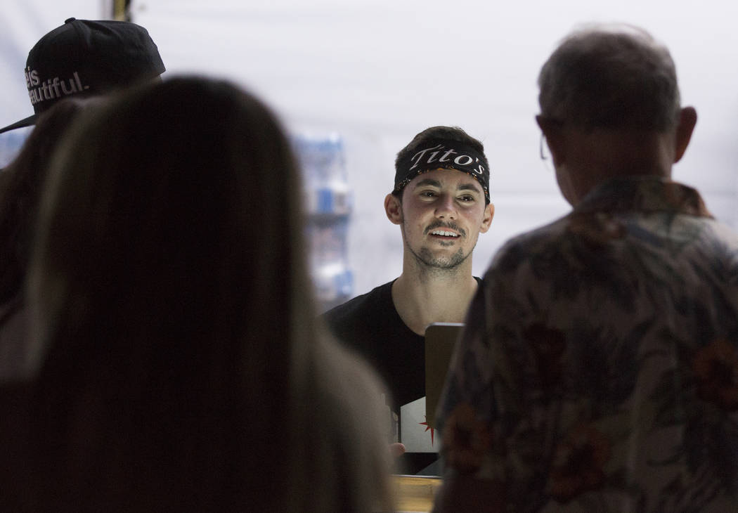 Luca Iclodean, second from right, takes customers' drink orders at Life is Beautiful on Friday, ...