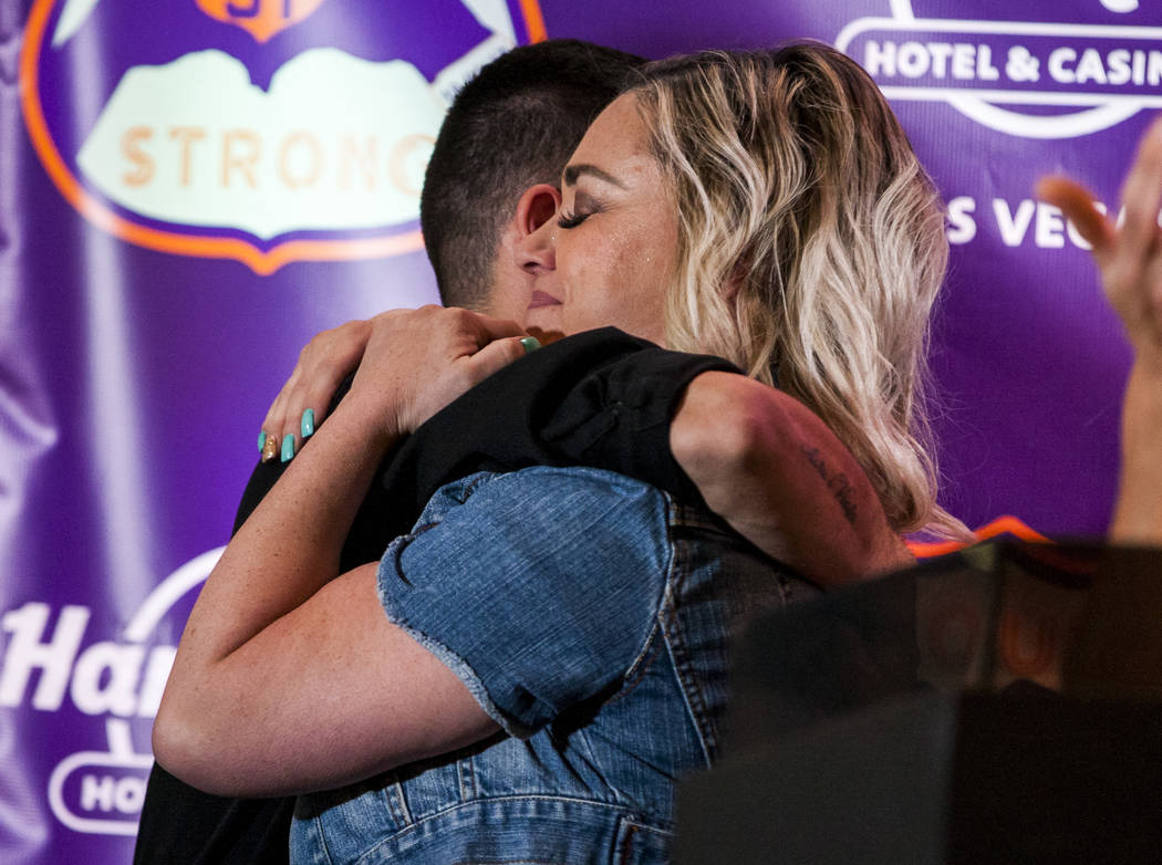 Oct. 1 shooting survivor Shayna Cataldo hugs Hard Rock Hotel employee Luca Iclodean after he di ...