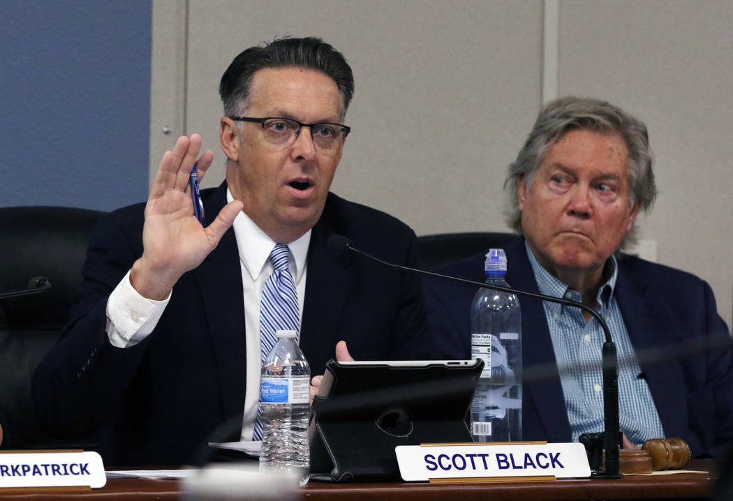 Scott Black, left, the Southern Nevada Health District chairman, speaks as board member Tick Se ...