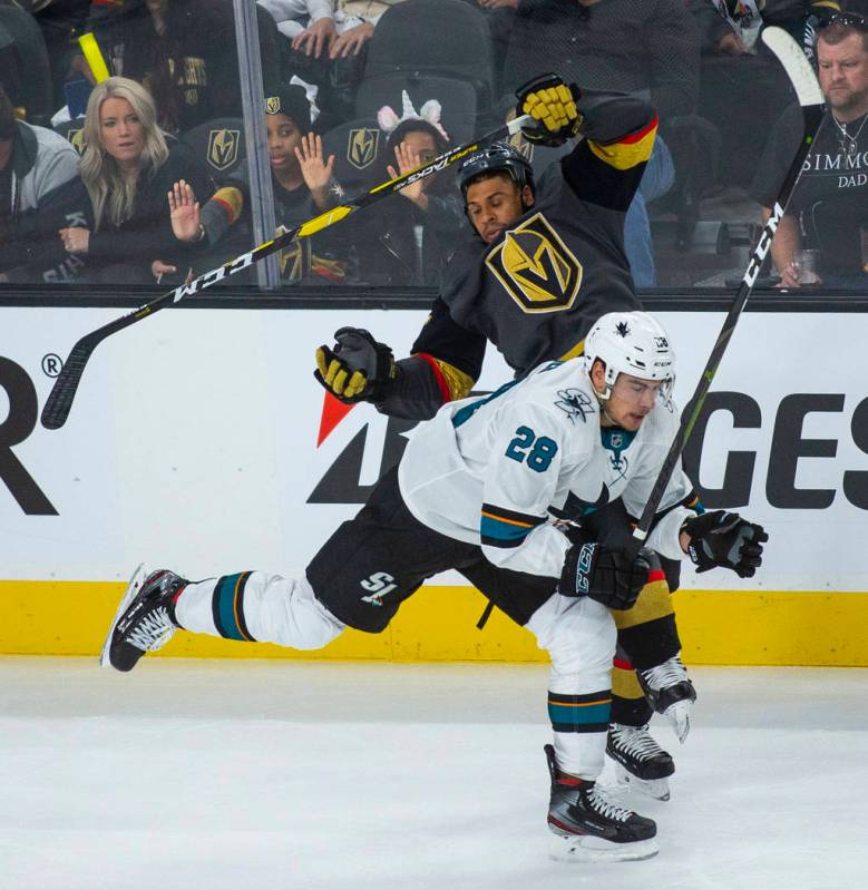 San Jose Sharks right wing Timo Meier (28) checks Golden Knights right wing Ryan Reaves (75) du ...